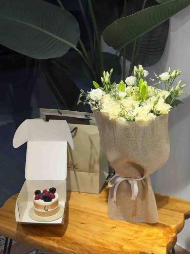 A bouquet of flowers with fabric wrapping and a ga...