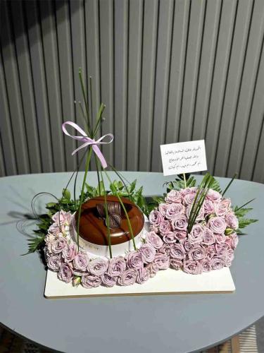 A flower and rose base with a cake that I and my e...