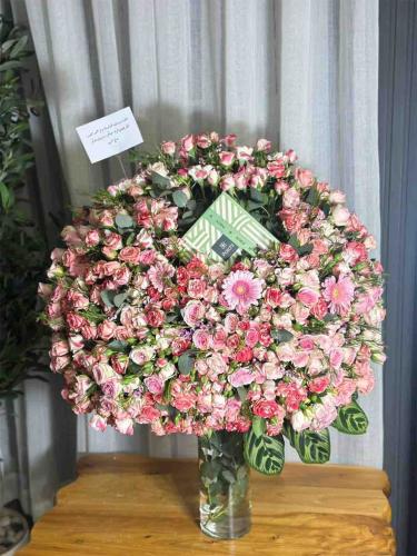 A large flower vase with Patchi chocolates