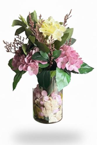 Luxury artificial flower arrangement inside a tran...