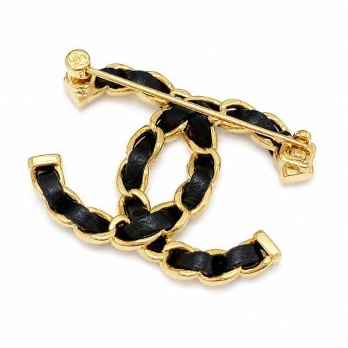 Chanel brooch with CC logo in black and gold