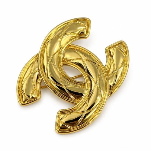 Chanel brooch with gold design and CC logo