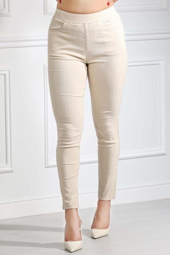 بنطال جينز خصر عالِ مطاطي بقصة ضيقة حتى الكاحل