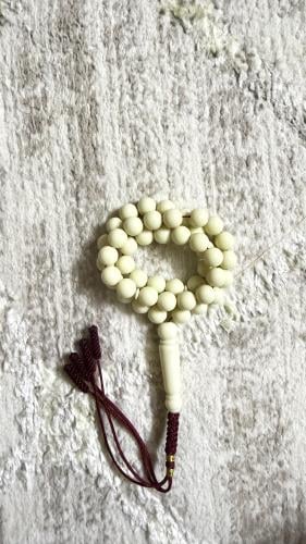 A tasbih with beige color, caramel color, red shap...