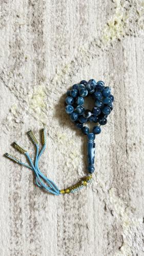 Turquoise-colored prayer beads mixed with a clasp.