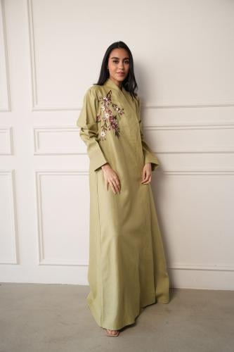A green abaya with embroidery on the back