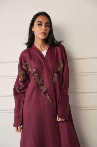 A luxurious maroon-colored abaya with hand embroidery