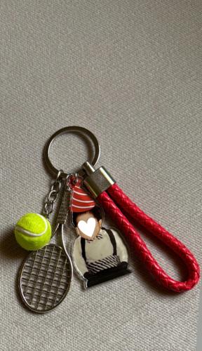 Tennis racket with ball with leather medal with ac...