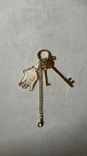 Golden-colored keychain with a personal photo