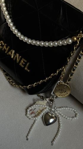 A bow-shaped pendant with a heart and a personal photo