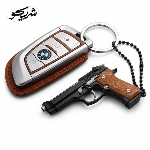 Car keychain in the shape of a small pistol