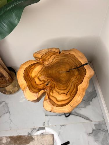 A serving table made of natural wood with the possibility to change the shape and size of the legs upon request