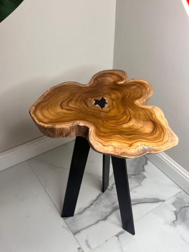 A serving table made of natural wood with the possibility to change the shape and size of the legs upon request