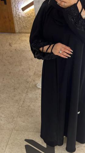 The Abaya of Authenticity black crystal with a sli...