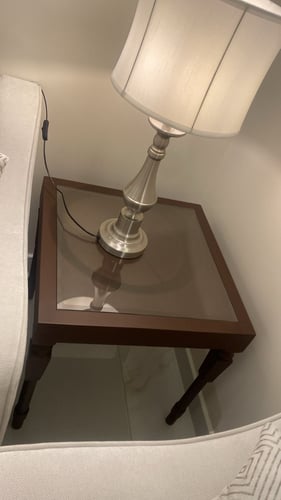 Corner table with honey-colored glass surface