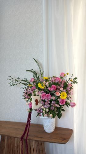 A large vase with a variety of roses
