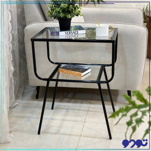 طاولة جانبية كمدينه بلون اسود و بسطح زجاجي شفاف