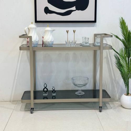 عربية تقديم بلون شمباني وبسطح زجاجي أسود