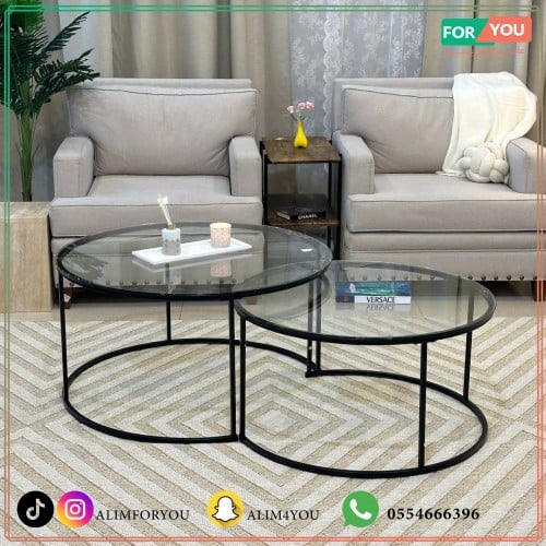 طقم طاولتين متداخلة بلون أسود وبسطح زجاجي شفاف