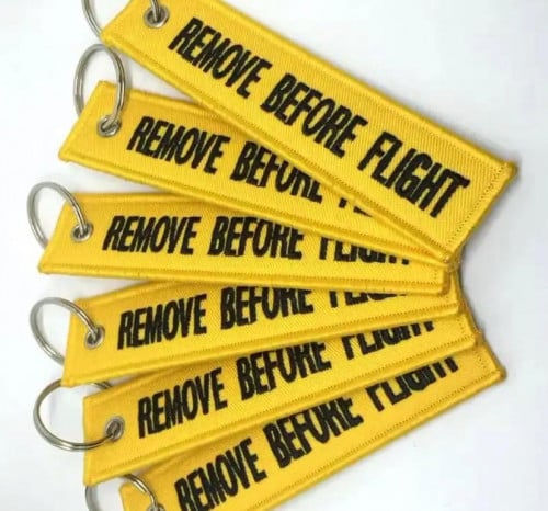 Remove before flight keychain in many colors