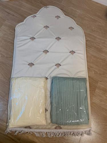 Bed sheet + prayer rug + Quran holder