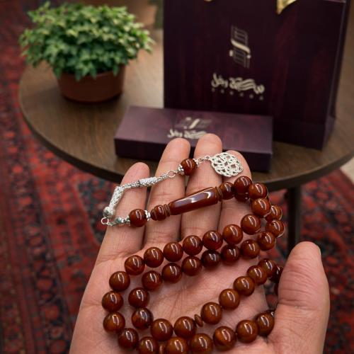 A beaded rosary with a metal tassel.