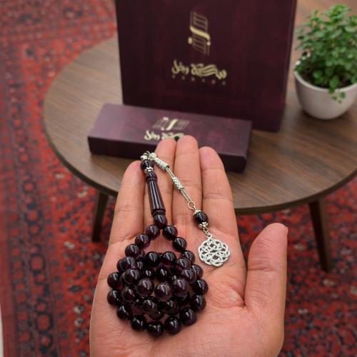 A beaded rosary with a metal tassel.