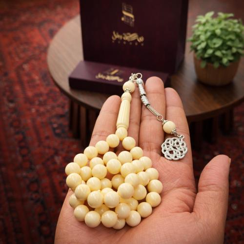 A beaded rosary with a metal tassel.
