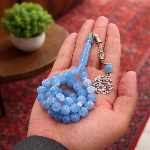 A beaded rosary with a metal tassel.