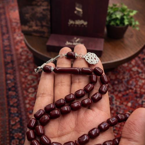 A beaded rosary with a metal tassel.