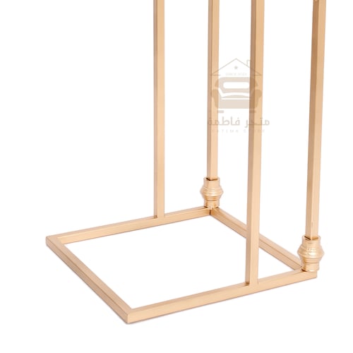 طاولة خدمة لون ذهبي وقواعد حديد سطح زجاج شفاف