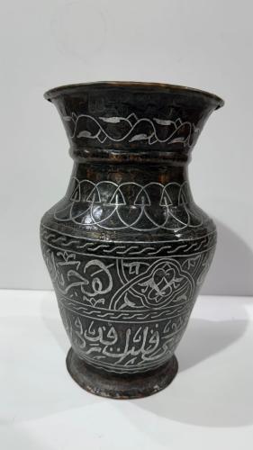 فازة نحاس عليها كتابات ومطعمه بماده شبيهه بالفضه