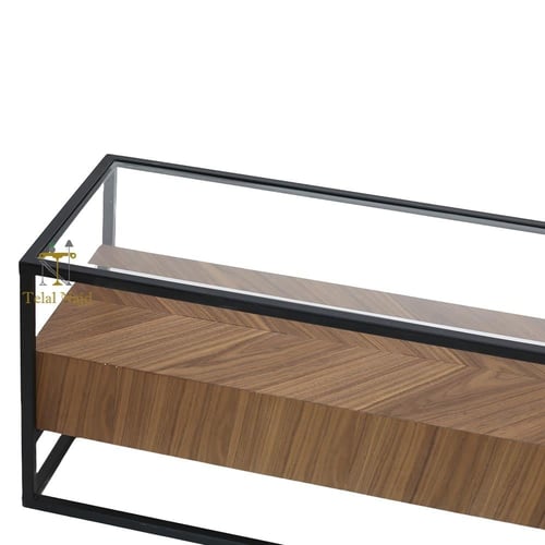 طاولة تلفزيون قاعدة حديد لون اسود سطح زجاج شفاف وق...