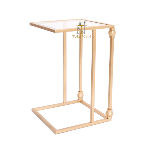 طاولة خدمة لون ذهبي وقواعد حديد سطح زجاج شفاف