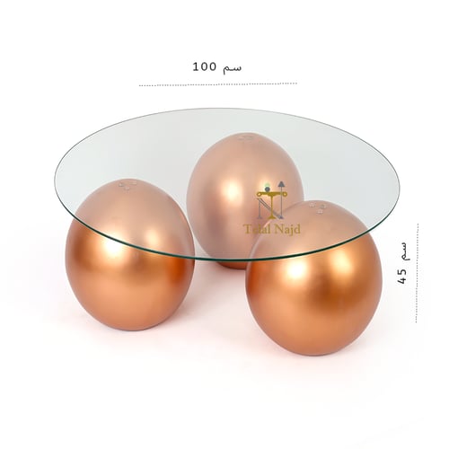 طاولة شكل كور رخام صناعي لون ذهبي وسطح زجاج شفاف