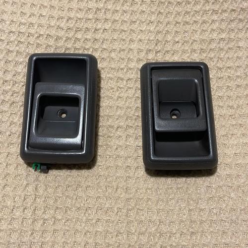 Right and left set of interior door handles in gra...