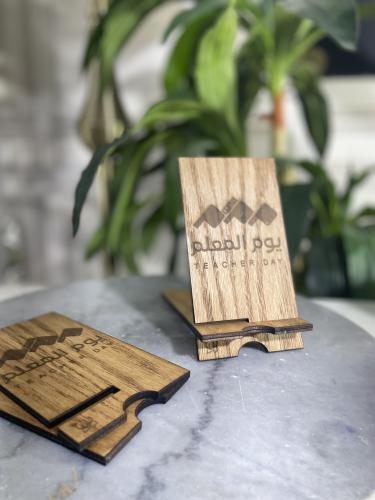 استاند جوال خشبي ويمكن اختيار الشعار حسب الطلب