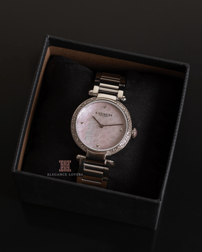 ساعة نسائية كريستال ماركة كوتش - فضي ميناء صدف ورد...