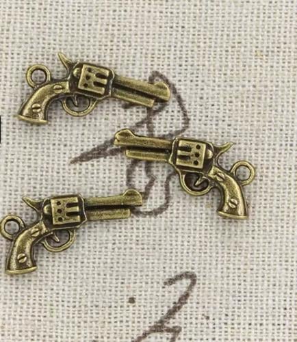 قطع معدنية شكل مسدس فضي 12 حبة