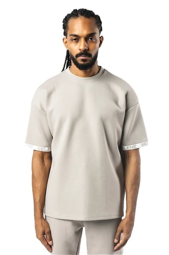 تي شيرت رمادي كبير للجنسين مع أكتاف منسدلة وشعار م...