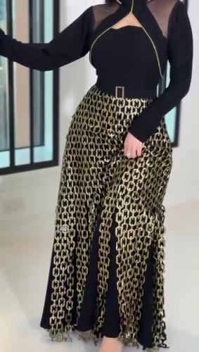 Luxurious black dress with gold chain details
