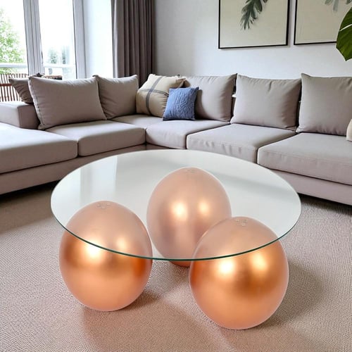 طاولة شكل كرات رخام صناعي لون ذهبي وسطح زجاج شفاف