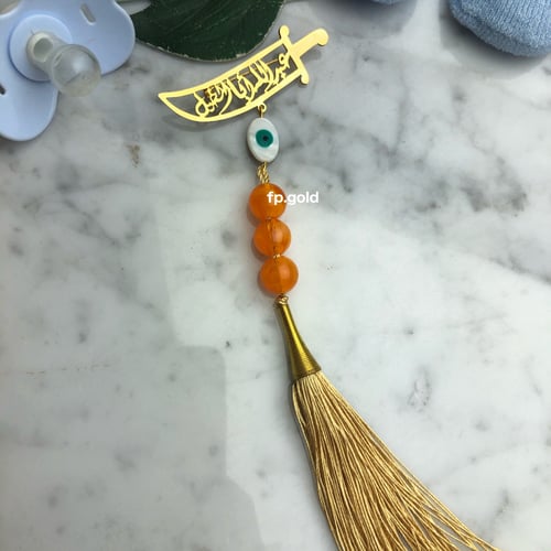 بروش السبحه السيف مطلي ذهب مع خرزه زرقاء بيضاوي ود...