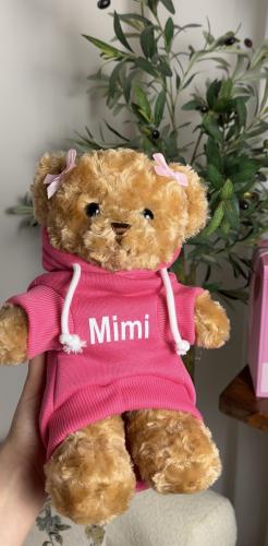 A teddy bear in dark pink