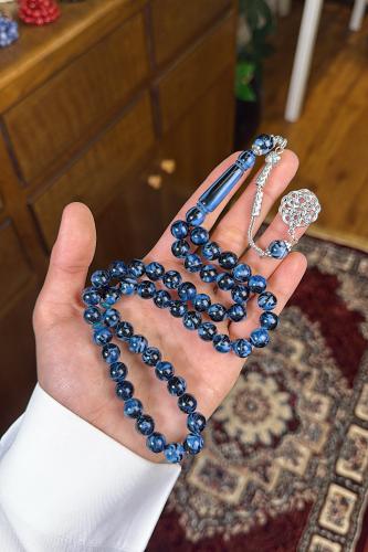 A turquoise metal beaded rosary