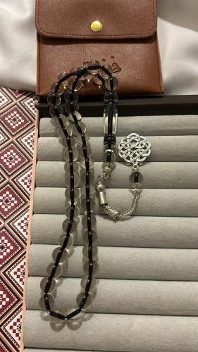 A transparent plastic rosary from outside and inside with a black thread