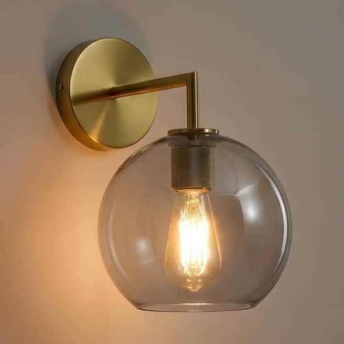 ابليك جداري مودرن ذهبي مع كرة زجاجية بلون رمادي