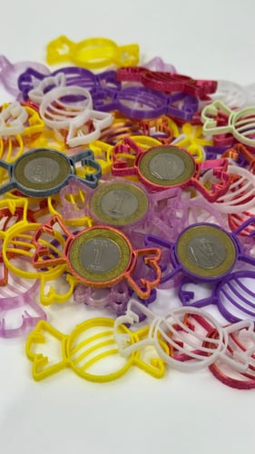 قطعة لتثبيت العملة المعدنية بشكل حلاوة (25) حبة