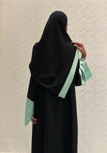 Black A-line abaya with glistering solid green sle...