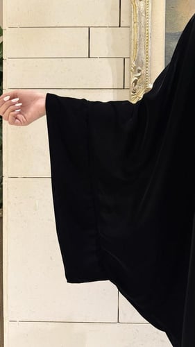 Black Velvet Bisht with extra-wide black sleeves.